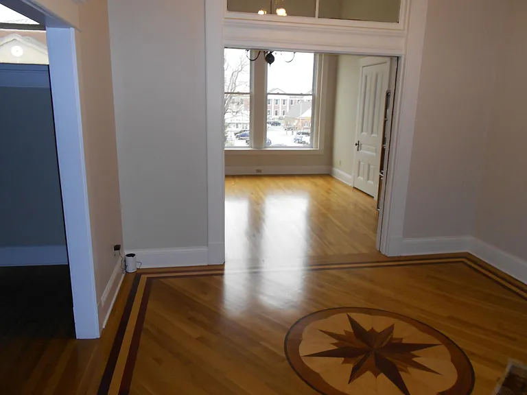 Foyer leading into living room and one of the dining rooms (and pantry).
