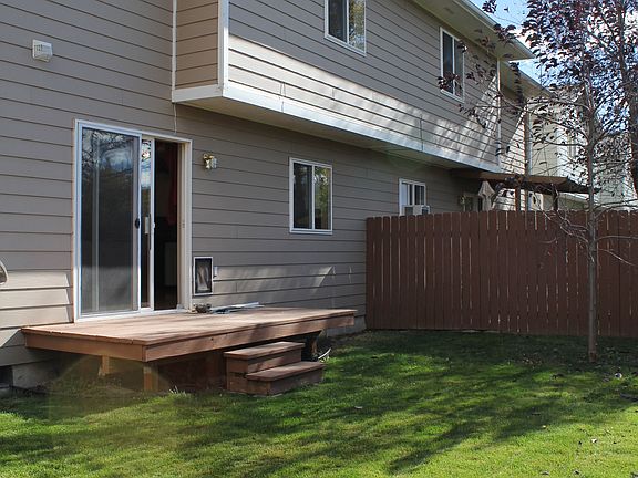 Patio door, kitchen window, and upstairs BR #2 look out onto the fully fenced backyard.