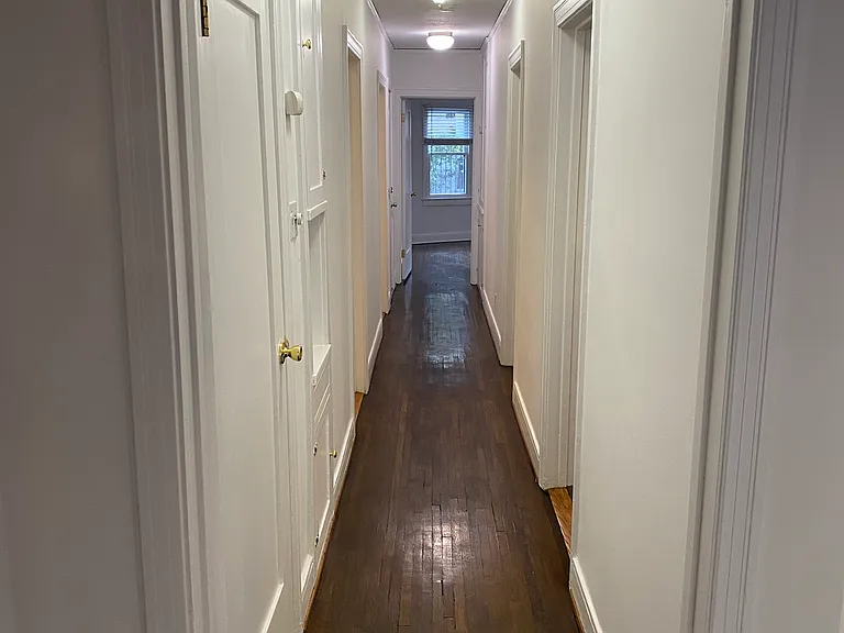 Extra Long Hallway Leading To Bedrooms and Bathrooms