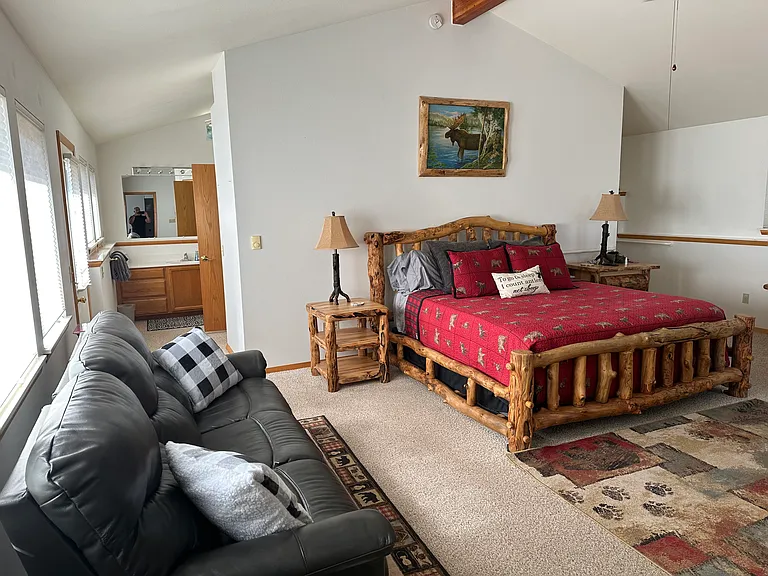 Primary bedroom with electric reclining leather couch