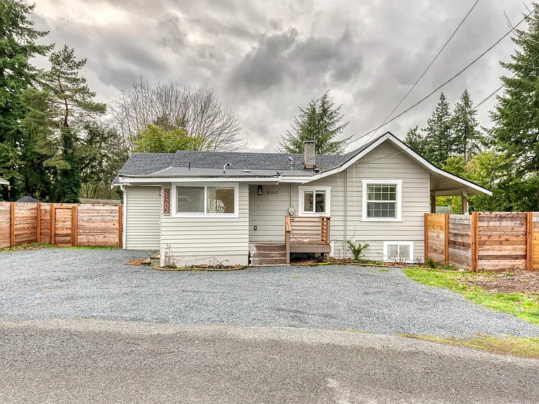 Another view of the farmhouse from the side that shows the mudroom. Guests will be parking in the gravel area.