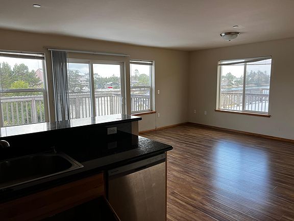 Nice open concept of living room dining room and kitchen with plenty of windows