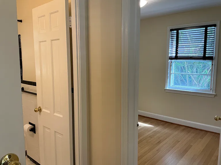 hall in between 2 bedrooms, bathroom and stairs to go upstairs