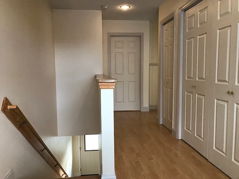 Hallway. Laundry Closet and Linen Closet. Bathroom Door at the end of the Hallway.