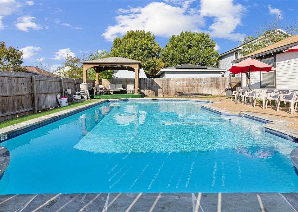 View of swimming pool with a gazebo and a patio
