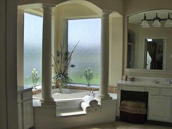 Master bath has a seperate arched tiled shower with two vanities.