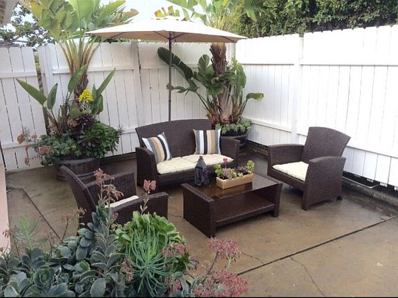 Your own private patio with palm & succulent pots. Furniture & umbrella are included. Globe string party lights, complete the picture. Fully enclosed & just for you!