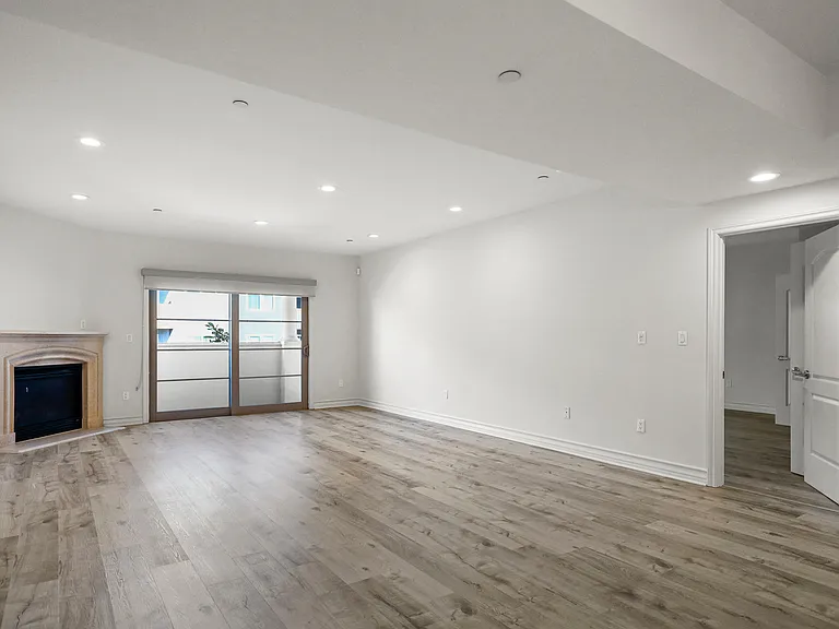 Large Living Room with a Fireplace and Balcony