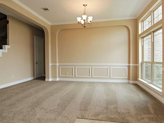 The formal dining room features crown molding, chair rail and picture moldings which are included in all of Gehan's Classic Series Homes.