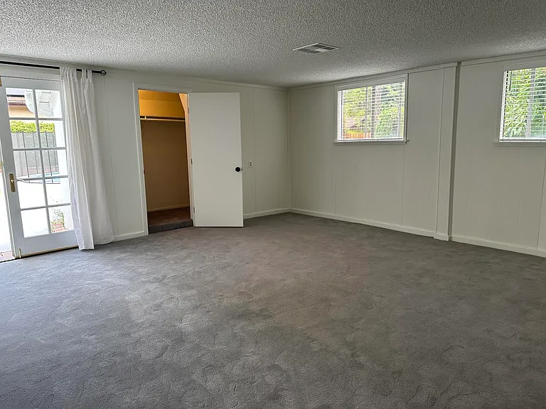 Converted Garage with Closet and doors to house and to patio