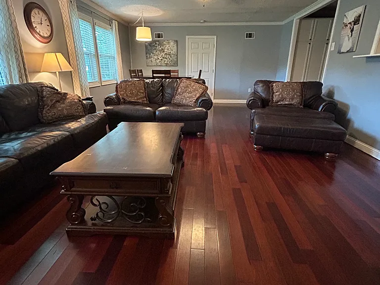 This photo of the main living room is taken from the view of the back door. The door ahead leads to the Master Suite.