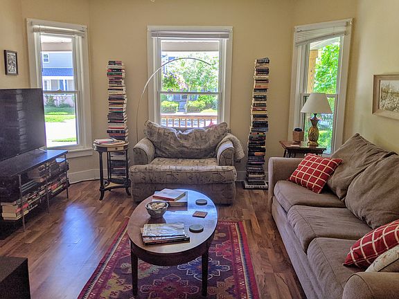 Bright bay windows and historic pocket doors give the living room lots of charisma.