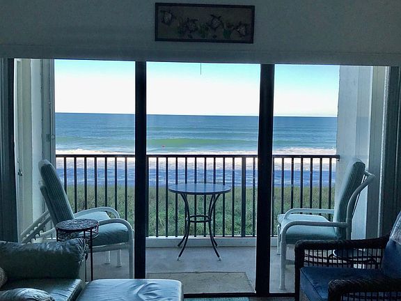 balcony with table and chairs. There are new sliders and shutters.