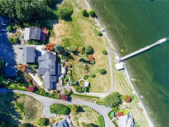 Private low bank waterfront on Henderson Bay. The 3 bd, 3 bath, 3,328 sf home, includes a dock and boat house plus 3 car garage. Beautiful landscaping on .83 acres.