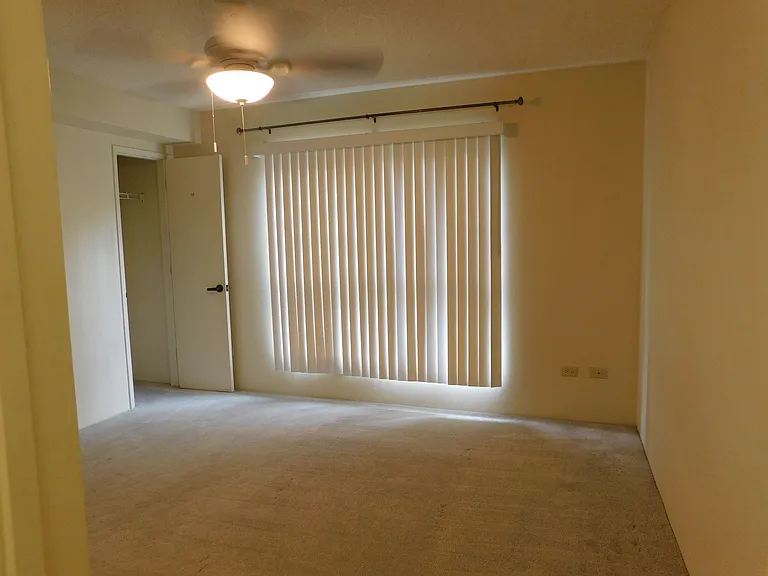 Primary bedroom with ceiling fan. Two closets