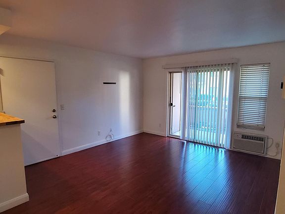 Living area, front door, kitchen and back patio, photo taken from dining area.