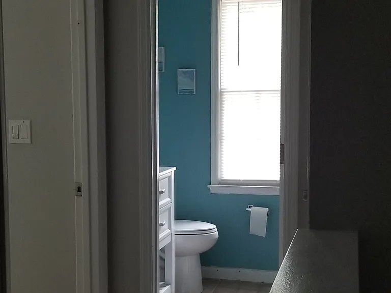 View from the second floor hallway towards the second full bathroom.