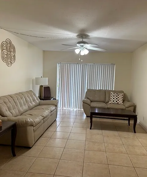 furnished living room with matching leather sofa and loveseat