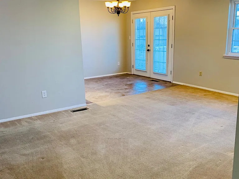 Dining room with double exterior doors to covered back patio