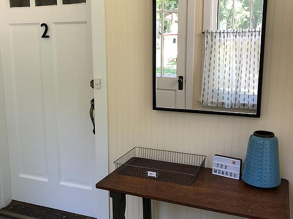 Enclosed front porch leads to private entrance.