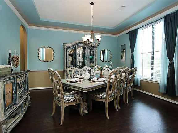 Crown molding, chair rail, an updated chandelier and gorgeous laminate floors add a touch of elegance to the formal dining room.