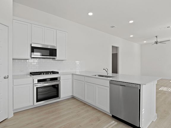 Kitchen in the Pecan II home plan by Trophy Signature Homes - REPRESENTATIVE PHOTO