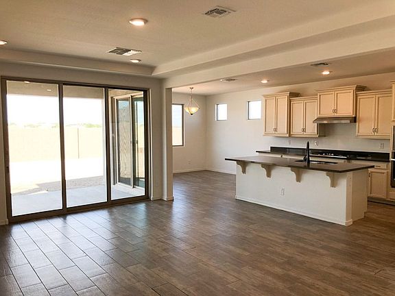 Jasmine Phoenix model home open concept plan great room and kitchen with breakfast area attached by