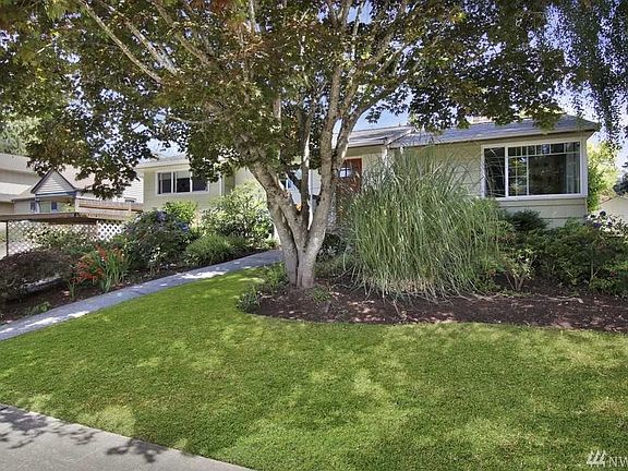 Another angle of the house showcasing beautiful, mature landscaping.