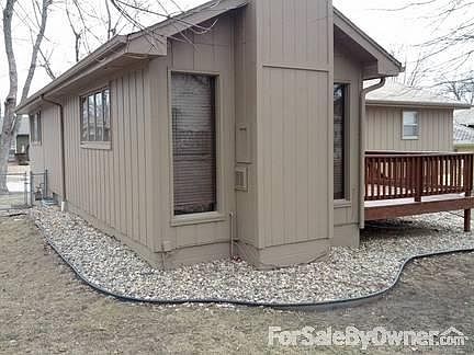 Addition with fireplace
						:
						River rock landscaping.