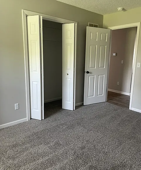 Master bedroom with his and her closets