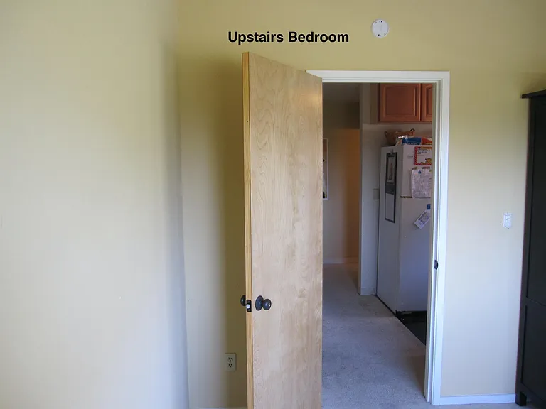 Upstairs bedroom #2 with view of kitchen behind