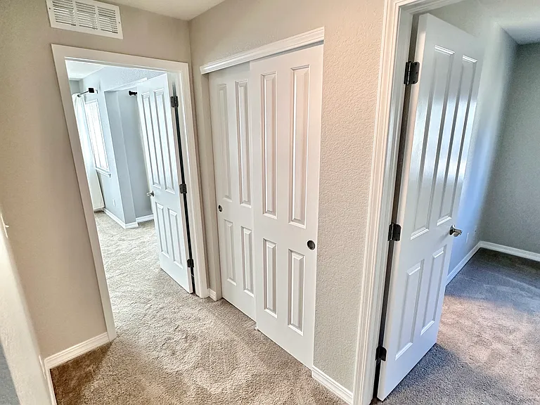 Upstairs hallway with linen closet.