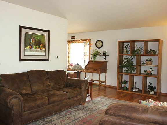 Bright, sunlit living room sets the tone right away with beautifully refinished hardwood flooring and fantastic decor.