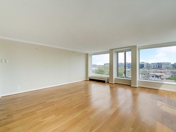 Large 18_3_ x 19_2_ living dining room with wraparound windows, gorgeous hardwood floors and an amazing view!
