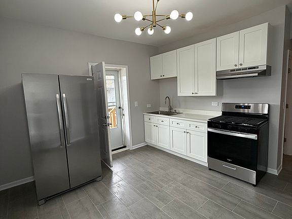 New Eat-In Kitchen with Gas Range, Full Size Fridge, and Solid Tile Floor.
