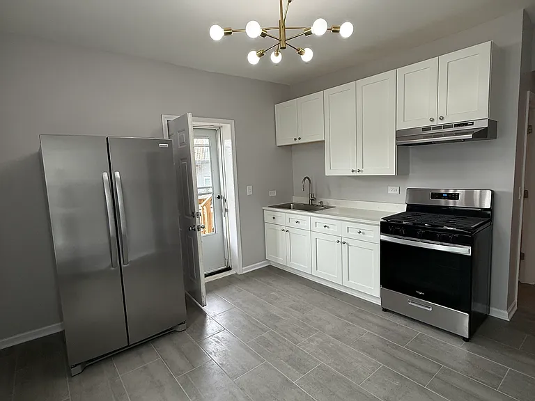 New Eat-In Kitchen with Gas Range, Full Size Fridge, and Solid Tile Floor.