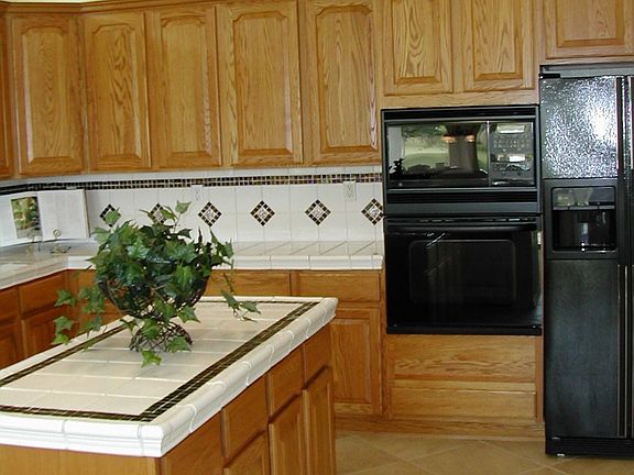 Kitchen includes island, refrigerator 