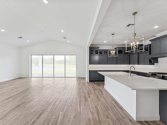 Great room dining area with soaring vaulted ceiling
