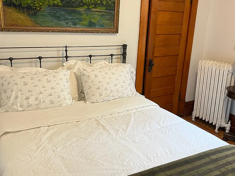 Bedroom #2 with new queen bed and original oil paintings.
