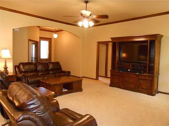 A nice arched opening separates the entry and study from the living.