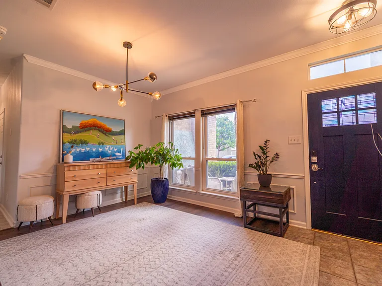 Bright & Airy Foyer: Step inside to a spacious, light-filled entryway that immediately feels like home. Featuring stylish modern lighting, beautiful flooring, and a grand staircase, this open foyer offers a fantastic first impression for guests.