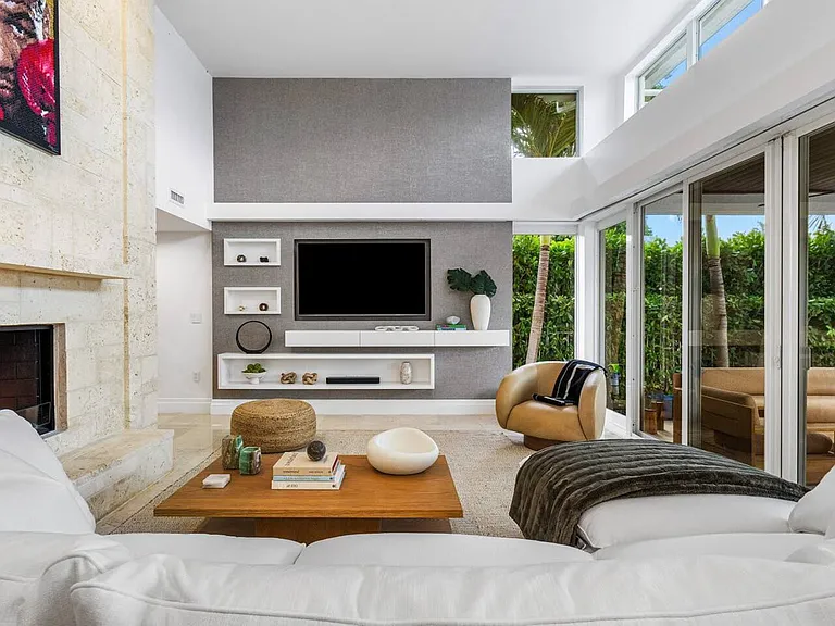 Expansive living room with floor-to-ceiling views and seamless access to the outdoor oasis.