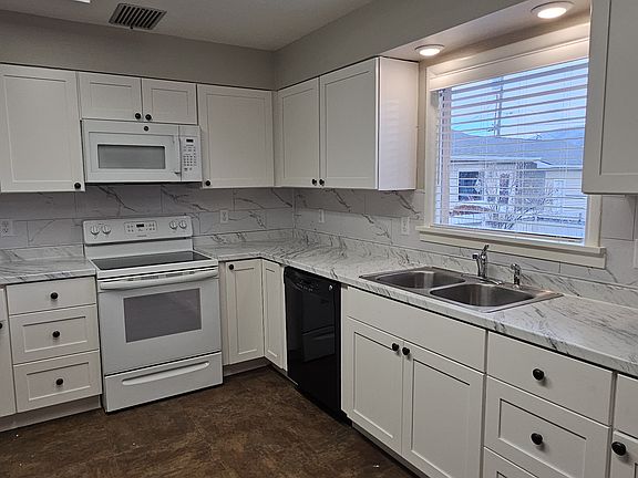 Kitchen with new cabinets with soft close doors and drawers, appliances, counter tops, and lighting. Room here for your own Island and casual seating.