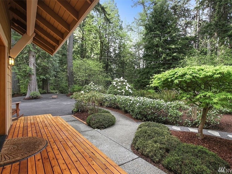Entry way showing the beautiful grounds and distinctive modern craftsman style of the home. 