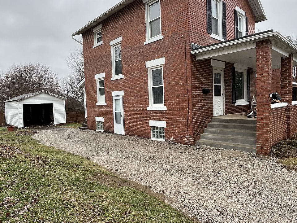 Outside of house with view of garage and new front porch.