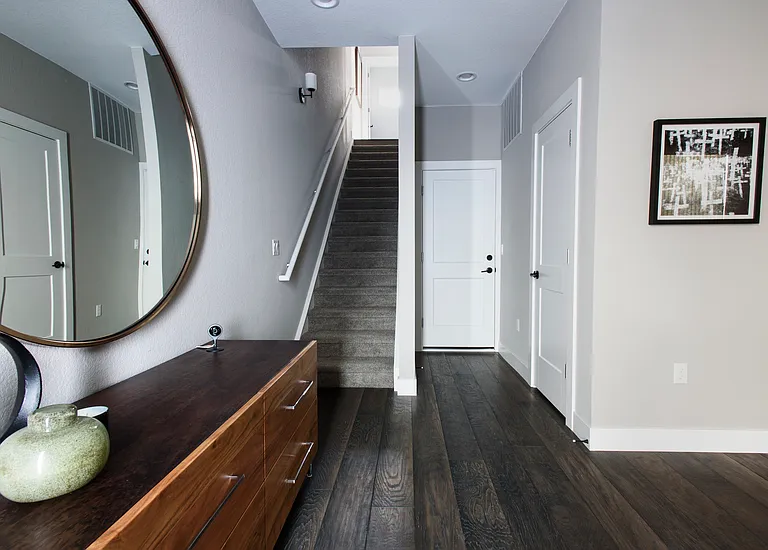 As soon as you enter front door, stairway to 2nd Floor, furthest door away leads to garage, with closet door to its right.