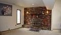 Huge Living/Family room with cozy stove insert. Perfect for large gathering.