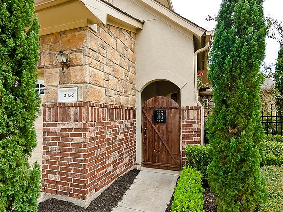 Welcome your friends & family to your new home.  Just through this charming gated entrance are arched openings leading to the front door and accented by decorative wrought iron fencing.
