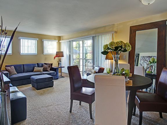 Living room with couch, table and large sliding glass doors leading out to the balcony
