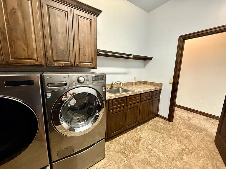 Easy access to your laundry room. Stainless steel appliances with a sink and large countertop. Tons of storage above the appliances and underneath the sink. Please note from the bedroom to the bathroom, master closet and laundry room makes a circle.